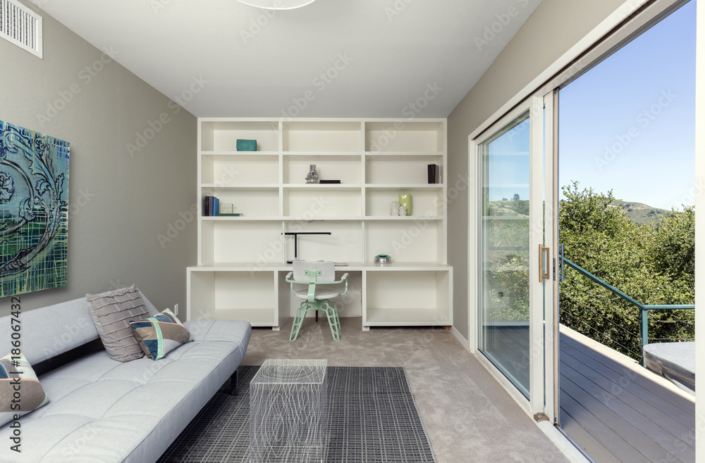 Open space home office with sliding door leading to outdoors. Open space home office with sliding door leading to outdoors.