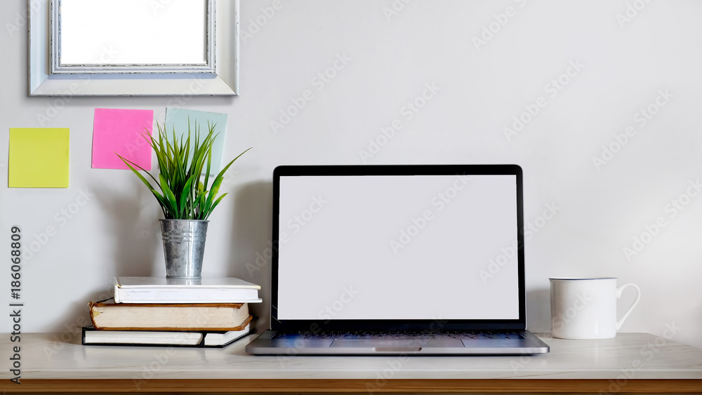 Mock up : Creative desktop with blank white laptop and supplies. Mock up : Creative desktop with blank white laptop and supplies.