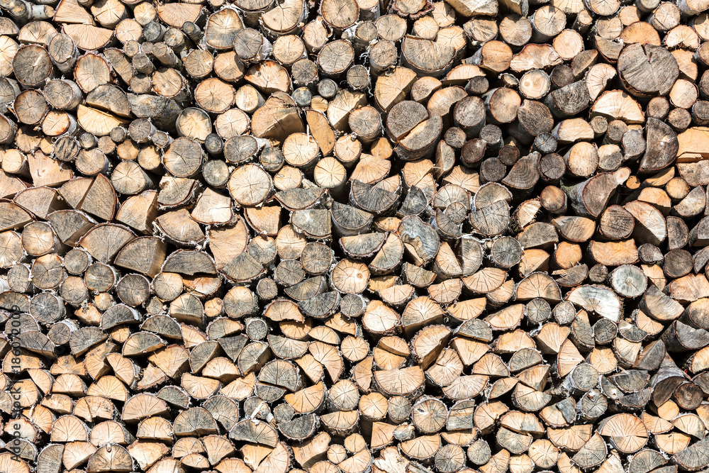 stack of chopped firewood prepared for winter. natural wood background. stack of chopped firewood prepared for winter. natural wood background.