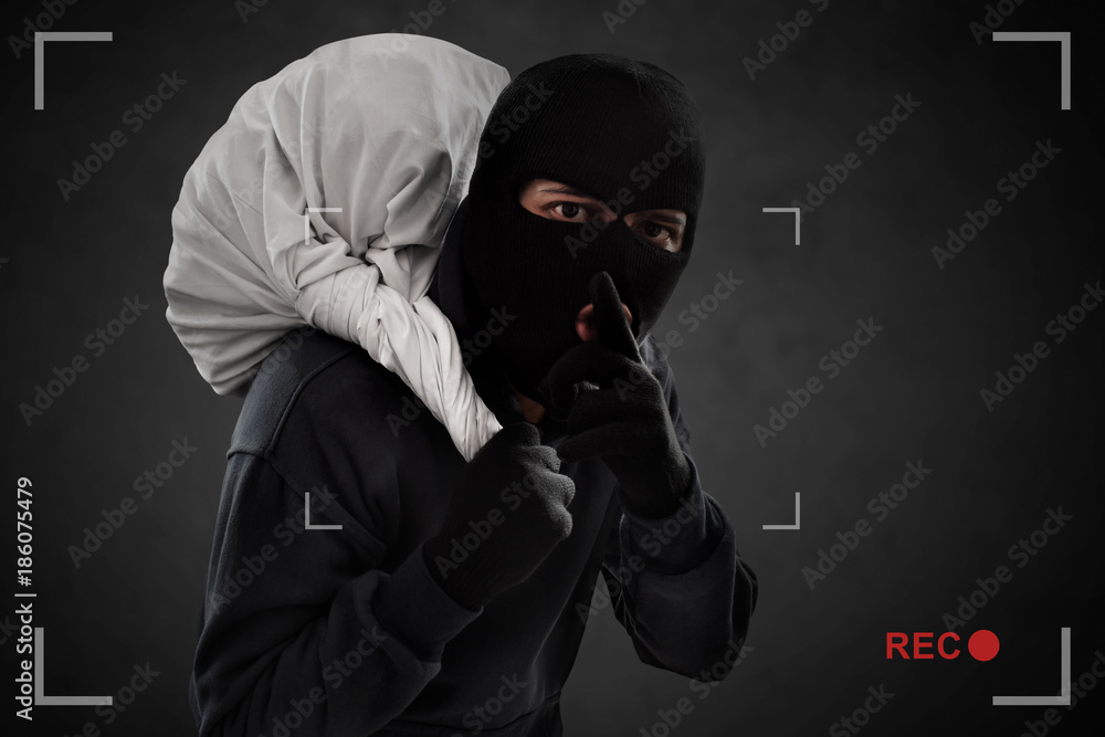 Masked thief caught on security cameras Masked thief caught on security cameras