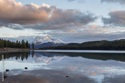 Maligne Lake at sunset time with Maligne Mountain in the distance.