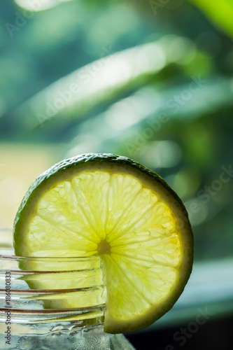 Lemon slice on glass jar.