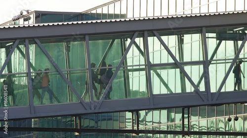Airline passengers go ramp from plane to international airport via a docking