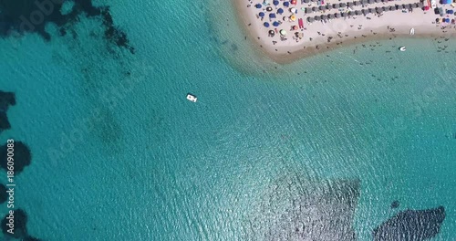 SARDINIA, ITALY  – JULY 2016 : Aerial shot of Tuerredda beach on a beautiful day with sea and boat in view photo
