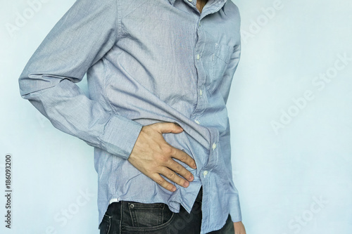 Konstfotografi Man with stomach pain on blue background