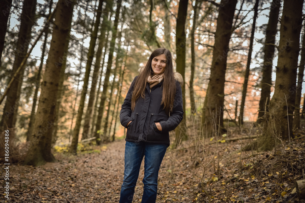 Young girl in the forest, smiling, looking at the camera Young girl in the forest, smiling, looking at the camera
