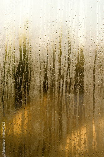 Drops on the glass window at dawn as background