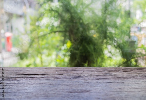 Empty wooden table, green nature bokeh background