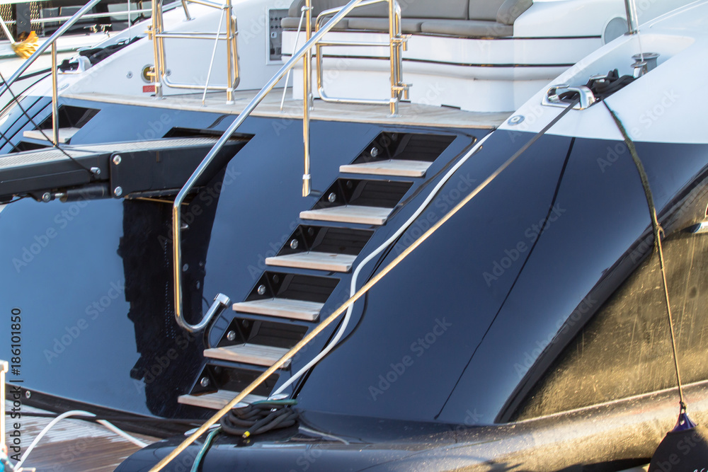 Moored black yacht at the pier