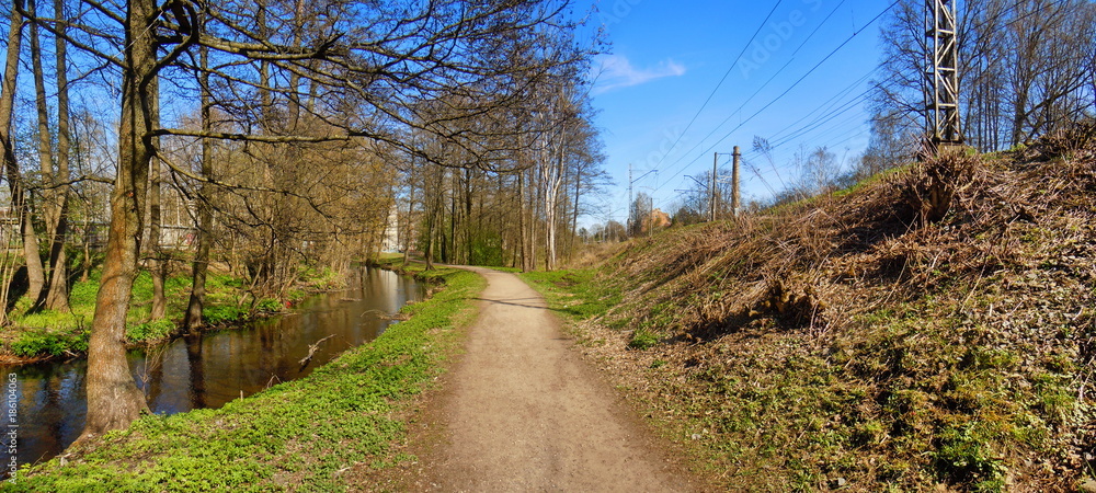 Panoramic view of small river, trail and railway embankment