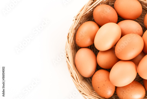 Fresh eggs in a wooden basket with copy space