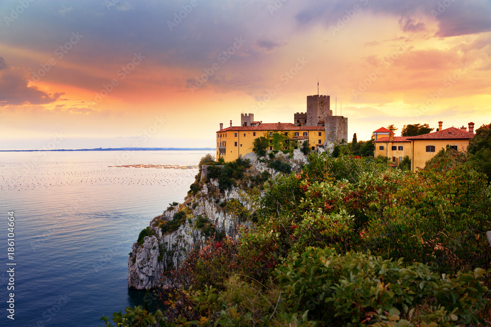 Amazing sunset over Mediterranean Duino Castle