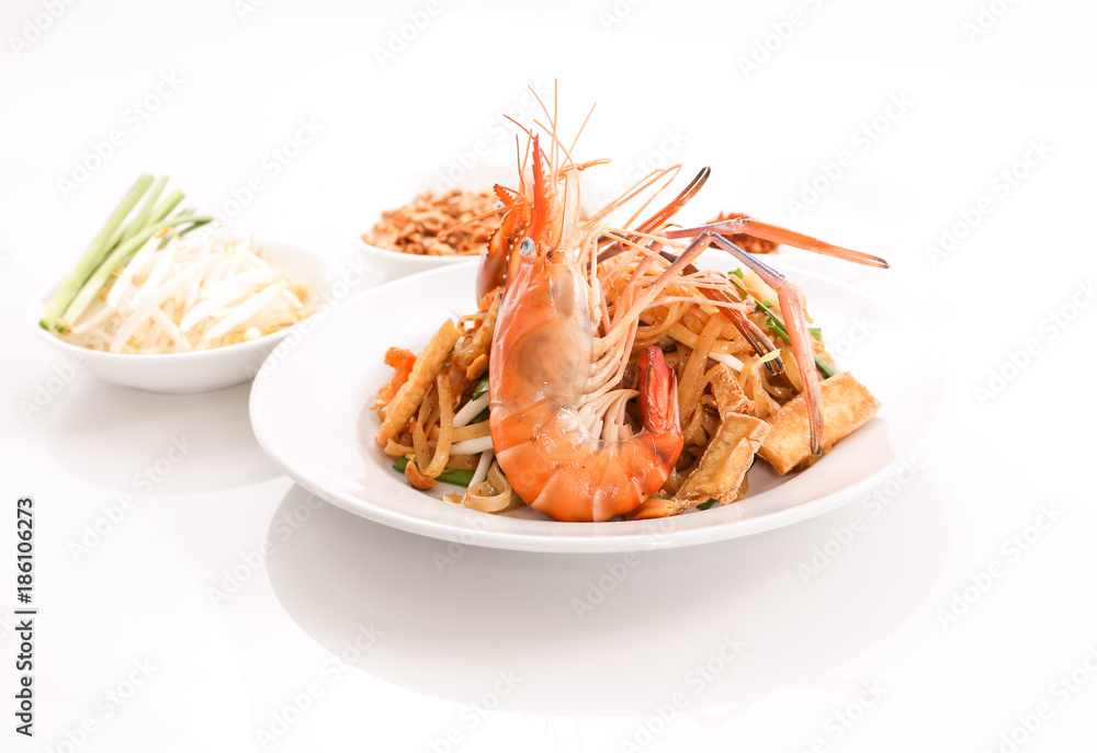 Thai cruisine - Pad Thai, stir-fried rice noodle dish with shrimp, egg and side dishes