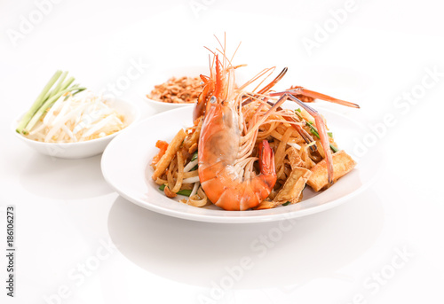 Thai cruisine - Pad Thai, stir-fried rice noodle dish with shrimp, egg and side dishes