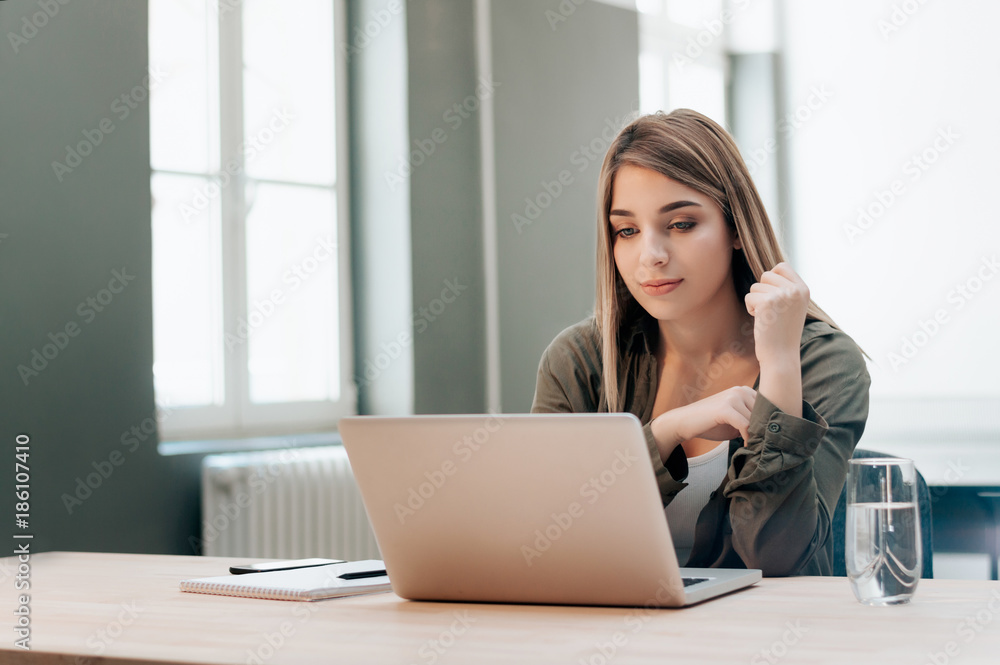 Happy female student with a laptop and notebook. Happy female student with a laptop and notebook.