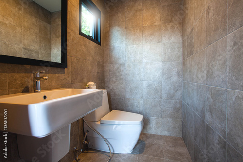 Luxury bathroom features basin  toilet bowl and bathtub