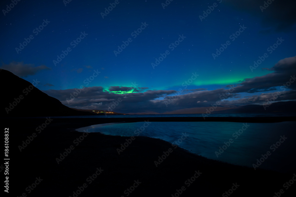 Fototapeta premium Northern lights background dancing over lake in Abisko national park in Sweden