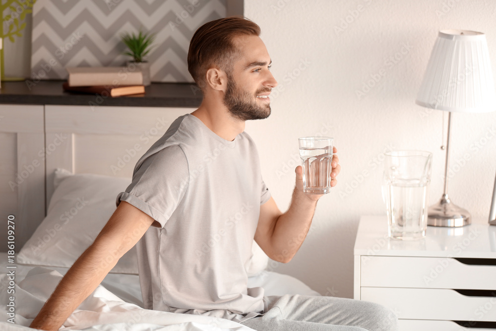 Morning of handsome young man drinking water at home Morning of handsome young man drinking water at home