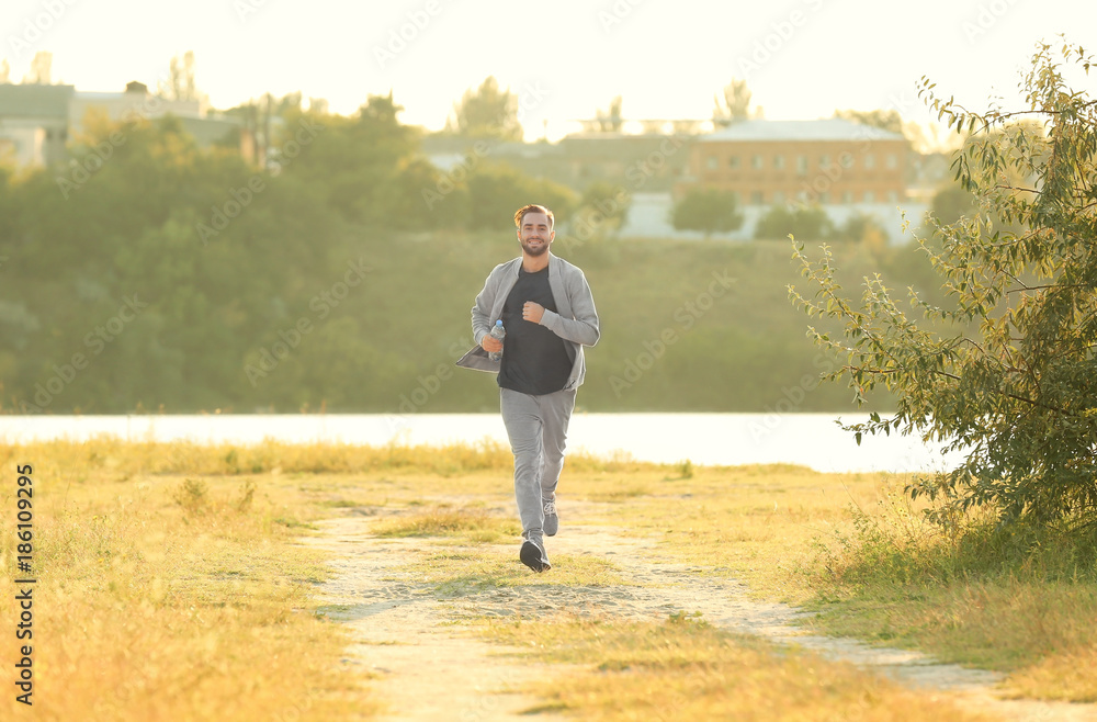 Sporty young man running outdoors
