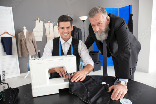 Tailor working on sewing ma...