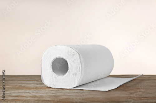 Roll of paper towels on table against light background