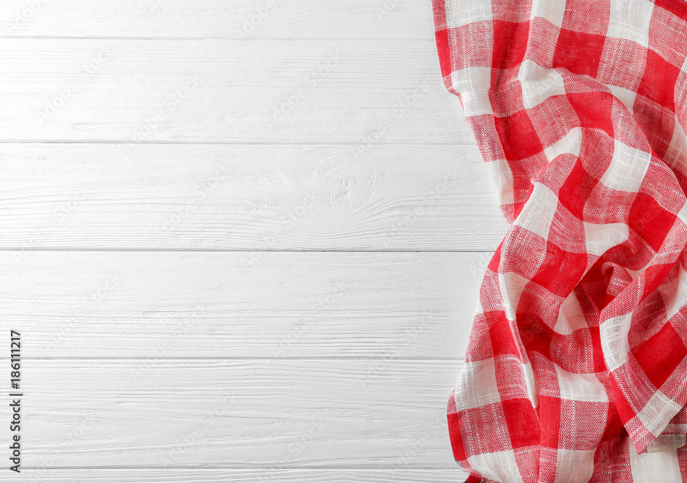 Checkered kitchen towel on white wooden table Checkered kitchen towel on white wooden table