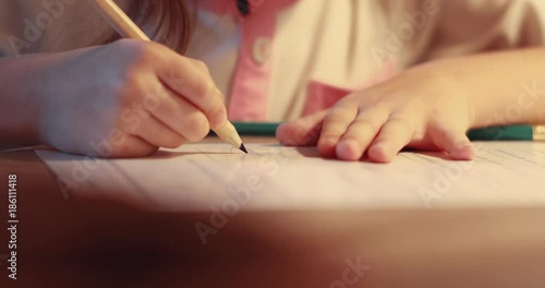 Close up hands little girl draw thinking near a beautifully decorated Christmas tree hands merry christmas lights magic portrait message surprise kid letter slow motion photo