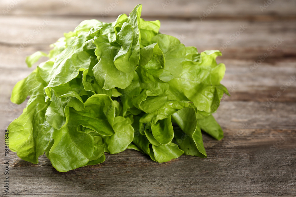 Bunch of fresh green salad on wooden table Bunch of fresh green salad on wooden table