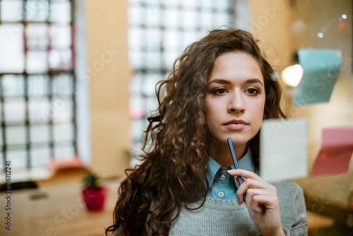 Concentrated woman making plan on sticky notes.