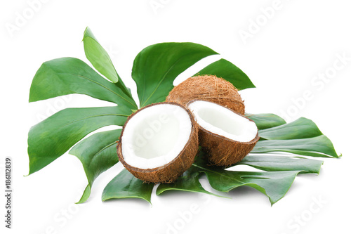 Ripe coconuts with leaf on white background