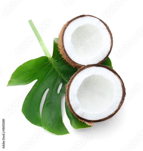 Halves of coconut with leaf on white background