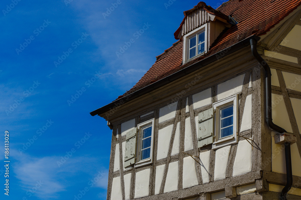 Residential tudor style house with blue sky in background