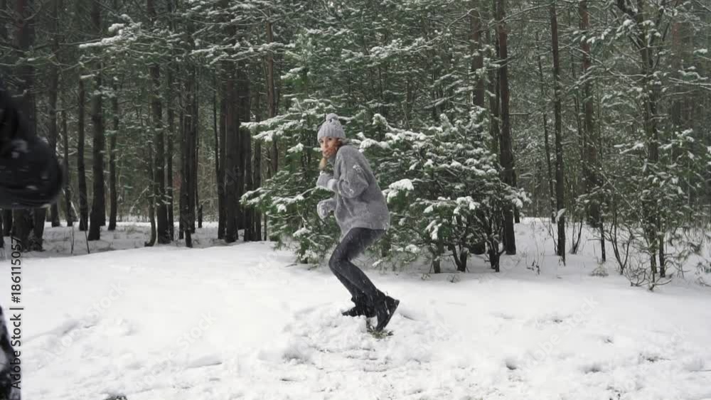 Couple man and girl playing snowball together and have fun. Slow mo Couple man and girl playing snowball together and have fun. Slow mo