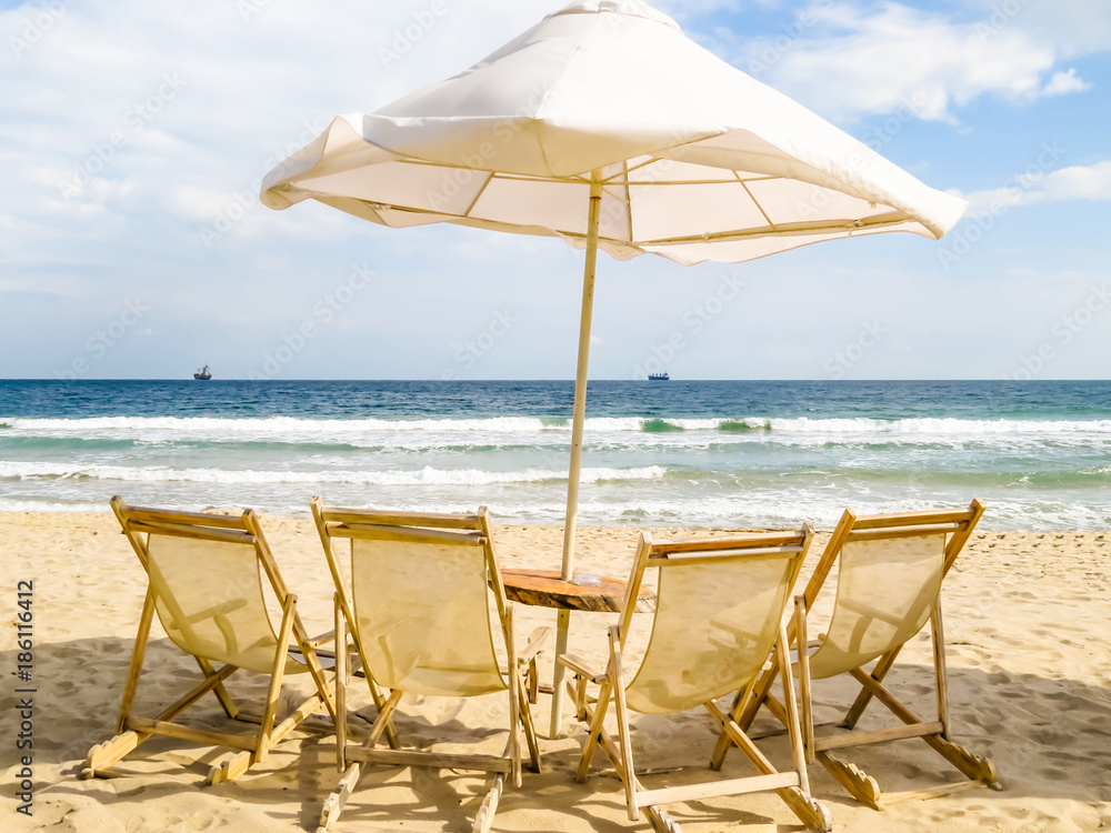 Beach chairs and umbrella on the sea coast