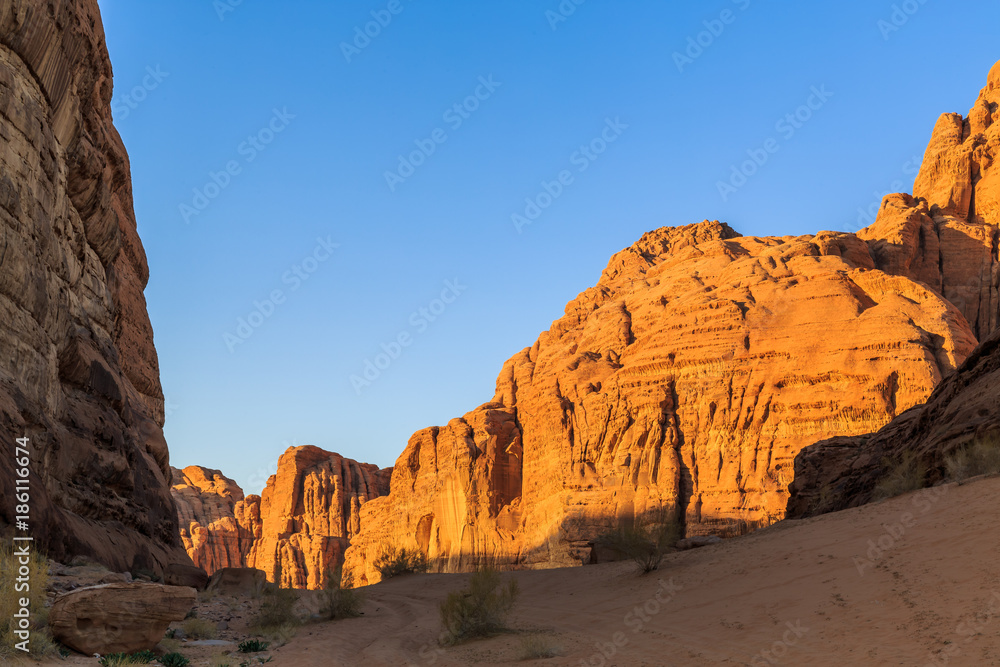 Scenic view of the yellow colored mountain rocks in the Wadi rum desert in Jordan at early-morning Scenic view of the yellow colored mountain rocks in the Wadi rum desert in Jordan at early-morning