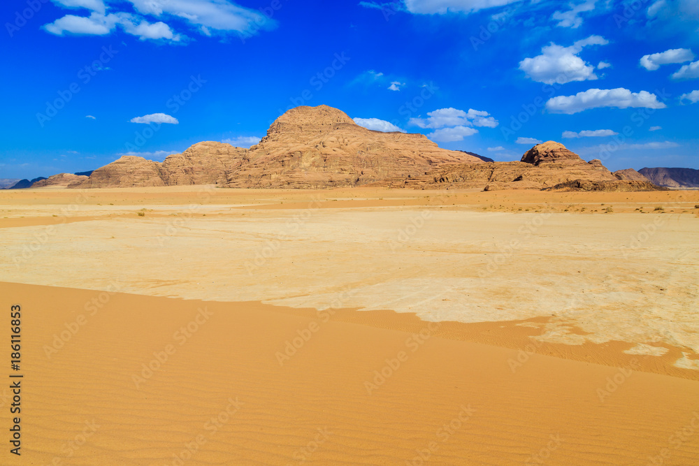 Landscape of the yellow colored mountain rocks in the Wadi rum desert in Jordan at early-morning
