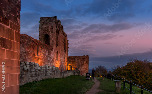 Beautiful sunset on ancient Stafford Castle with colorful sky and light on castle.