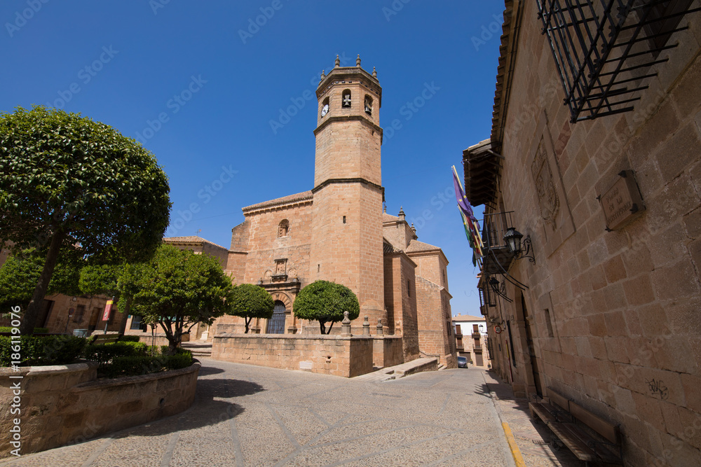 landmark street and bell tower of church of San Mateo or St Matthew, gothic and renaissance from Fifteenth century, in old town of Banos de la Encina, Jaen, Andalusia, Spain Europe
