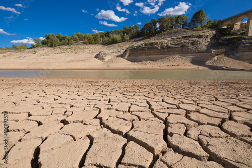 landscape of dry earth ground and low level water, extreme drought in Entrepenas reservoir, in Guadalajara, Castilla, Spain Europe 