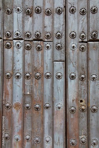 detail of ornate ancient wooden door of church San Mateo, from Fifteenth century, with metal pieces pattern, in Banos de la Encina, Jaen, Andalusia, Spain Europe
 photo