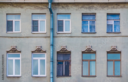 Several windows in a row on the facade of the urban historic building front view, Saint Petersburg, Russia 