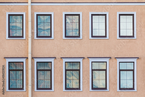 Several windows in a row on the facade of the urban historic building front view, Saint Petersburg, Russia 