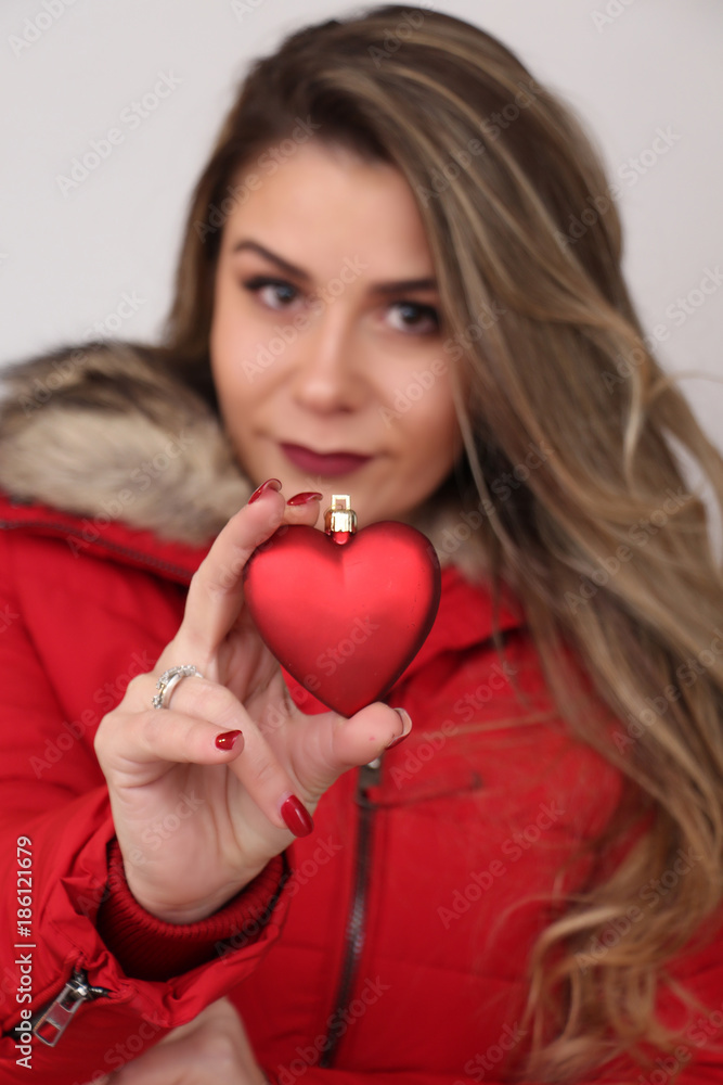 studio portrait of a beautiful model girl, holding heart studio portrait of a beautiful model girl, holding heart