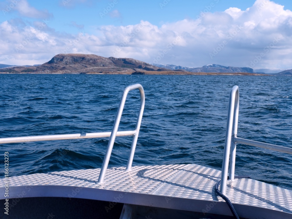 Fototapeta premium Sport boat sailing in blue mediterranean tranquil sea. Rocky island at horizon