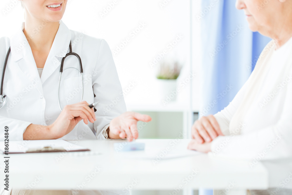 Doctor with stethoscope during consultation Doctor with stethoscope during consultation
