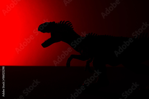 allosaurus shadow with red light in dark © Freer