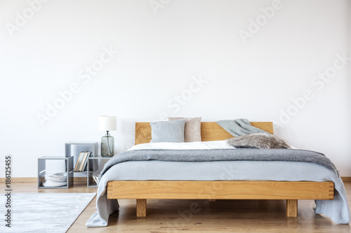 Wooden king-size bed in bedroom