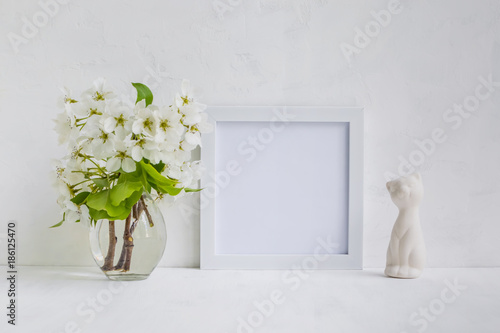 Fototapeta Naklejka Na Ścianę i Meble -  Mockup with a white frame and white flowers