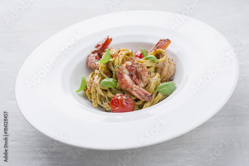 Traditional Italian tagliatelle ai gamberoni with tomatoes as close-up on a plate