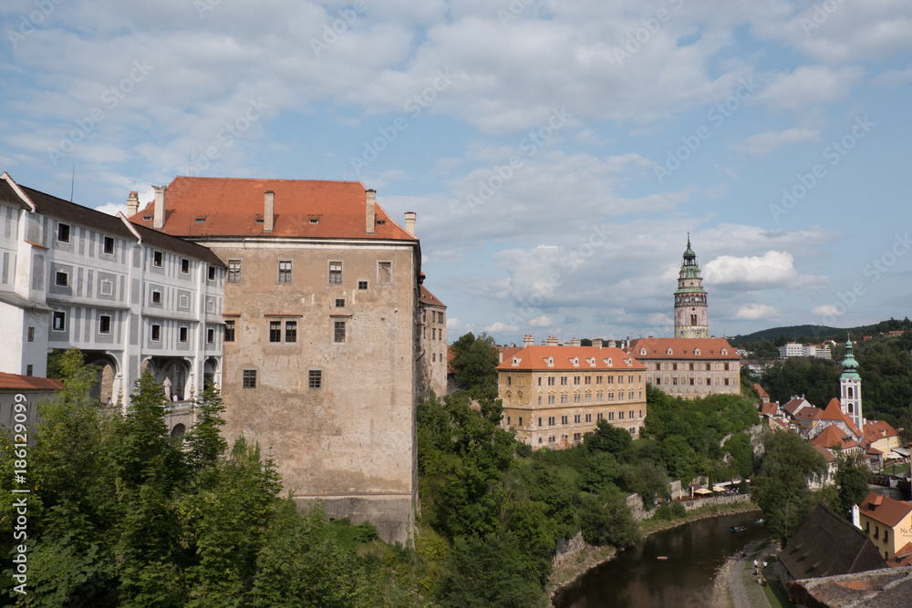View of the charming medieval town, Cesky Krumlov, from the castle. Renaissance Castle Tower and the Church of St Jost (Kostel sv Josta) in the background. Vltava River down below flowing through town